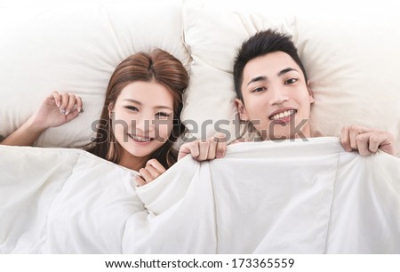 Young man and woman in bed. Couple