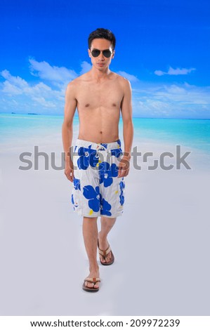 sunny man wearing beach short and Flip Flops walking at beach background