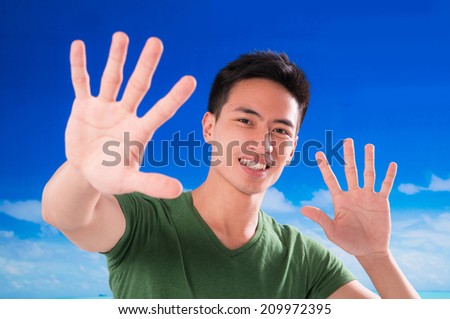 Young man with hands gesture in outdoor