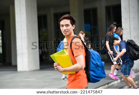 Portrait of college student working holding book at college