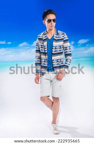 Full body Handsome young man walking at beach background