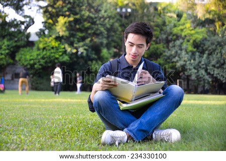 college student sitting holding book at college