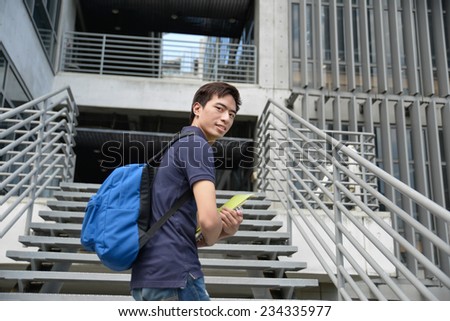 Portrait of college student standing at college