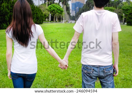 Back People in love with couple holding hands in park.