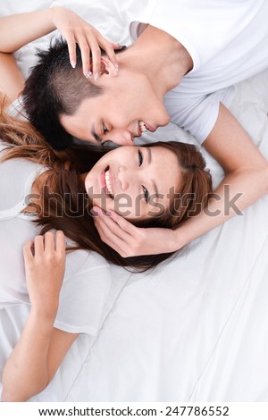 Happy loving couple in bed