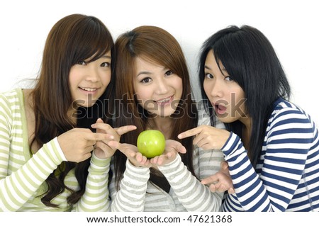 three female friends show green apple
