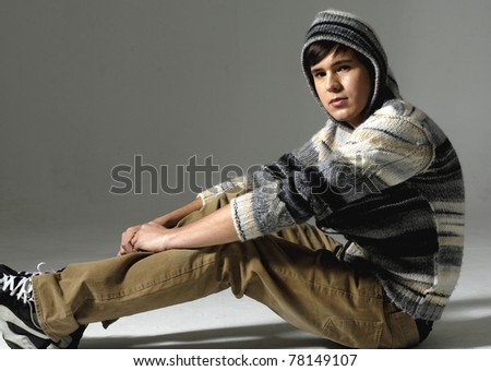 relaxed young man sitting on the floor