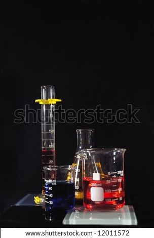 Several beakers with colored chemicals