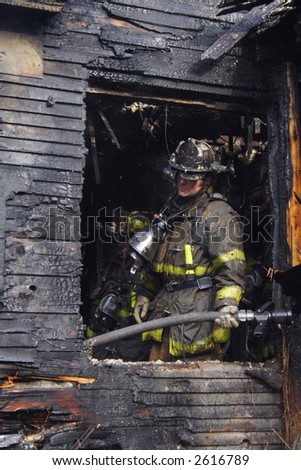 A Detroit Fireman examining the damage of an urban fire