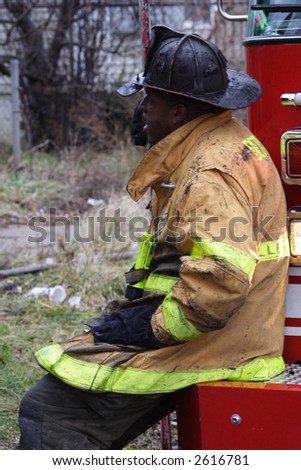 Chief Fireman sitting on the truck resting after the fire.
