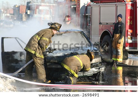 Firemen putting out a car fire in Detroit