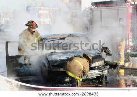 Detroit Firemen putting out a car fire