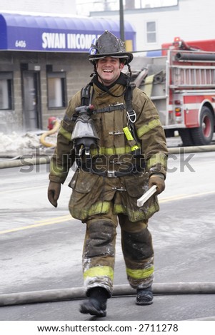 Happy Detroit fireman walking down the street after putting out a fire