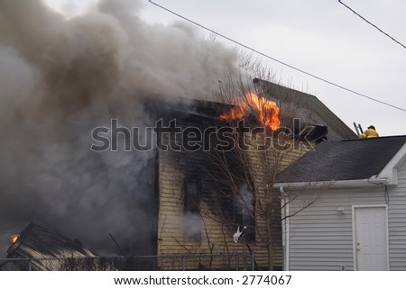 Detroit house filled with billowing smoke and flames coming through the roof