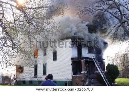 A large three story home in Detroit on fire