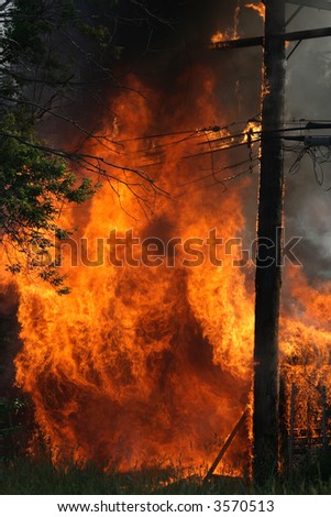 Huge garage fire catches an electrical pole on fire