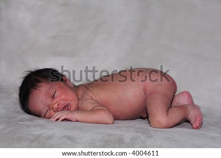 A portrait of a newborn baby in its birthday suit