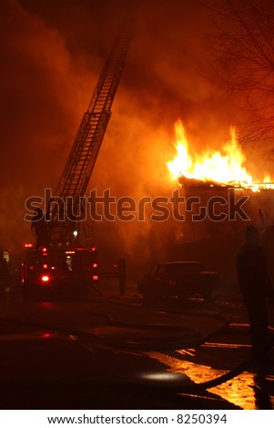 A night inferno seen from behind the firetruck