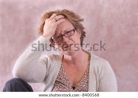 A frustrated middle aged female with a discouraged expression