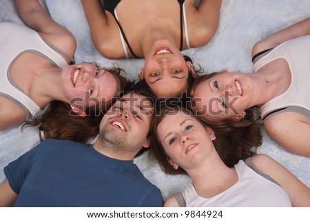 A close-up of a circle of college friends faces