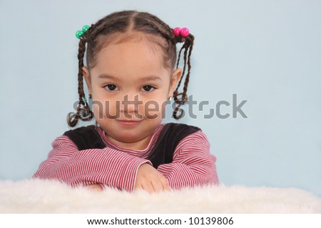 three year old girl posed with a silly smile