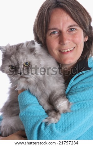 A middle aged lady happily holding a persian cat