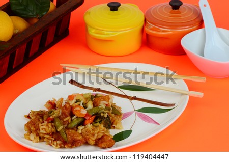 Orange Chicken Chinese Dinner on white plate with Oriental Bamboo Pattern on colorful background.