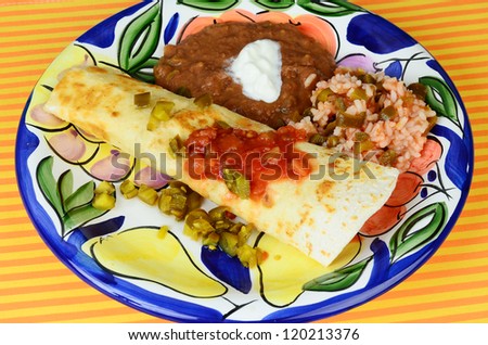 Bean and Cheese Burrito on colorful plate with refried beans and Spanish rice.