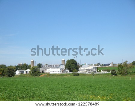 Series of white farm buildings and silos in Amish area near Lancaster Pennsylvania.
