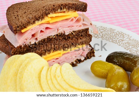 Ham piled high on pumpernickel with cheese and chipotle mayonnaise.  Served with sweet pickles and potato chips.