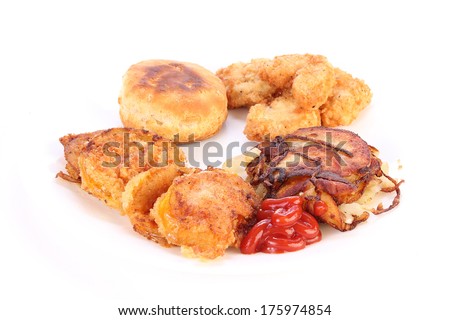 Greasy Soul food plate with fried green tomatoes; homefries and deep-fried chicken medallions is extremely high cholesterol and unhealthy fats but very hard to resist Southern Cooking.