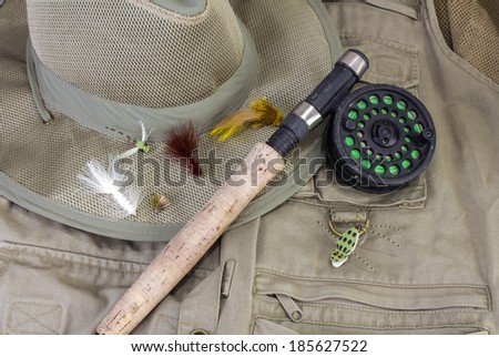 Fly Rod with lures against fishing vest and hat.