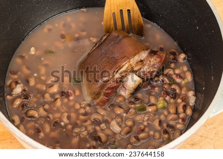 Ham hock adds flavor to large pot of black-eyed peas being prepared for traditional New Years Meal.