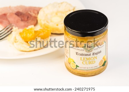 LLANO, TEXAS-DEC 28, 2014:  Jar of Harrowgate Fine Foods Traditional English Lemon Curd with breakfast plate in background.