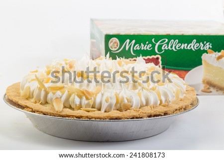 LLANO, TEXAS-Jan 05, 2015:   Made from scratch Marie Callender\'s Banana Cream Pie in aluminum pie pan with Packaging as background.