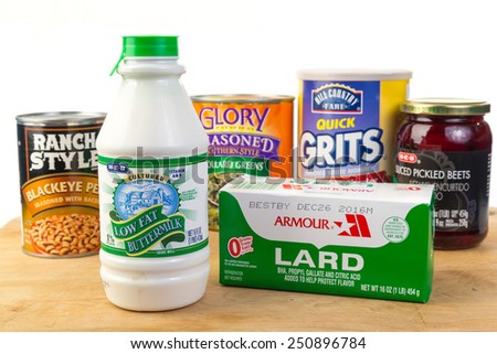 LLANO, TEXAS-FEB 08, 2015:  Bottle of buttermilk and box of lard in foreground with Soul Food items.  White background with copy space..
