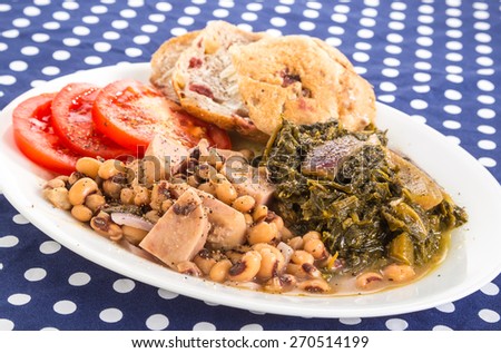 Soul Food Supper of Chunks of Spam in Black-eyed Peas with Collard Greens and sliced tomatoes.  Seasoned with salt pork and chopped red onions.  Blue Polka Dot Country Kitchen Tablecloth.