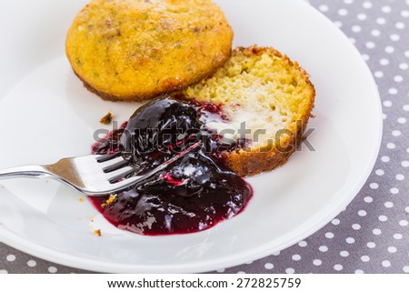 Serving of seedless blackberry jam with hot buttered cornbread muffin.  Traditional Southern Soul Food Dessert.