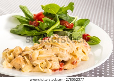 Chicken and shrimp with noodles in white sauce.  Dinner salad with mixture of lettuce and cherry tomatoes.