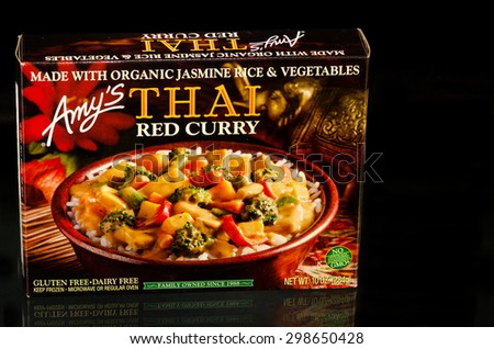 LLANO TX-JULY 20, 2015:  Frozen Amy\'s Thai Red Curry dinner with organic Jasmine Rice and Vegetables on black background with copy space.
