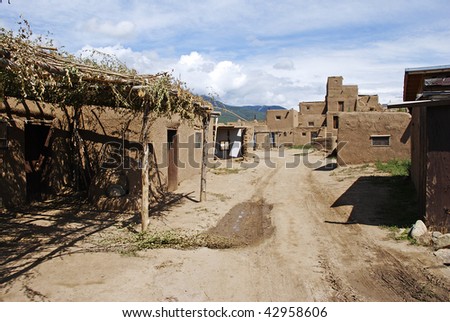 A back street leading through the adobe homes of Taos Pueblo in Taos, New Mexico.