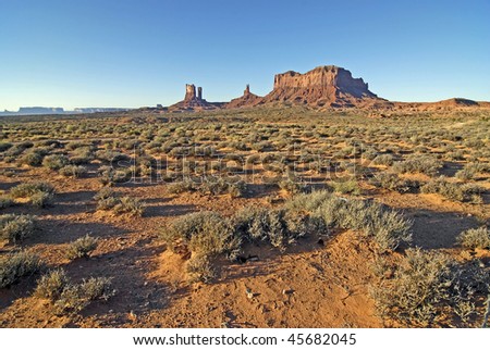 Early Morning sun creates long shadows over this desert landscape in Monument Valley Utah, Navajo Nation Tribal Park.