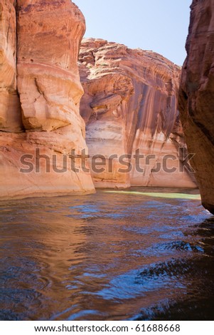 Narrow canyons lined by steep sandstone cliffs carefully navigated by charter boats from Glen Canyon National Recreation Area, Lake Powell near Page, Arizona.