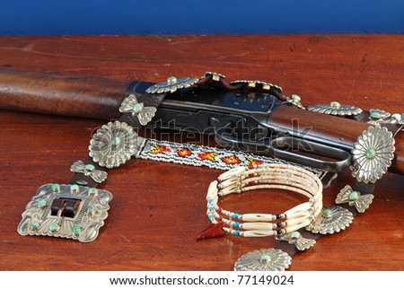 Southwestern Still Life with assorted Native American Turquoise, Silver and beaded jewelry scattered around a vintage lever action repeating western rifle.
