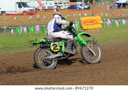 JEFFERSON, TX - APR 17: Mark Ray powers out of corner on classic Kawasaki KX420  in Diamond Don\'s AHRMA Riverport National Post-Vintage Motocross Race on April 17, 2011 in Jefferson, Texas.