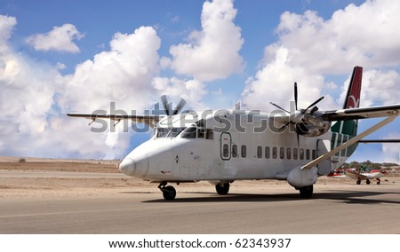 Airplane with propellers landing on a desert airport