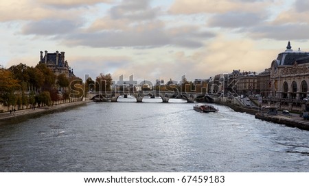 View of a bridge and the seine river in Paris at the evening