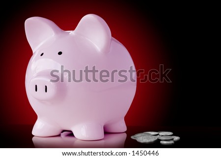 Pink piggy bank with loose change.