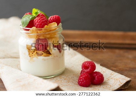 yogurt for breakfast with nuts, raspberry and milk. Diet for Women