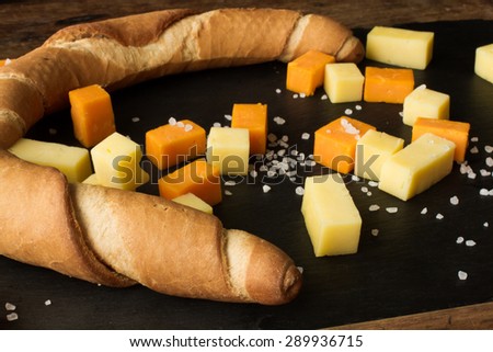 yellow and white cheddar cheese on a black background